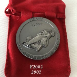 Official Ferrari F1 World Championship 2002 Titanium Medal / Coin + COA from the Official Motorsport Merchandise store collection.